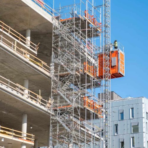 Worker working on structure of scaffolding